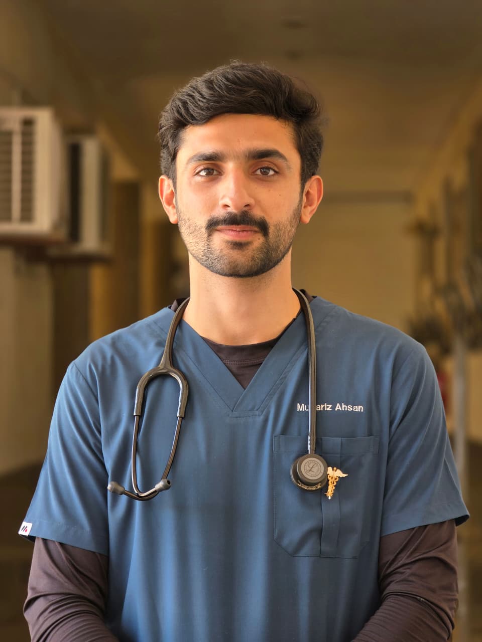 Mubariz Ahsan Awan in medical scrubs